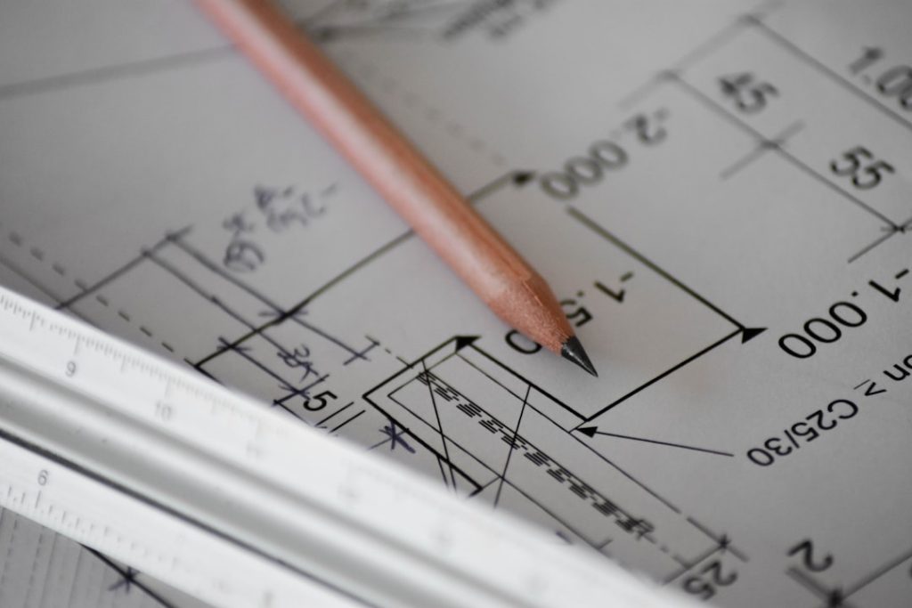 Property documents and survey plan being reviewed before purchase