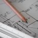 Property documents and survey plan being reviewed before purchase