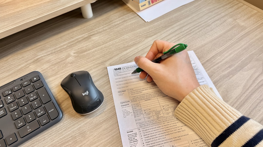 Hands reviewing and filling property verification paperwork at a desk