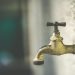 Clean water flowing from a tap, the payoff of a home borehole and water system in Nigeria