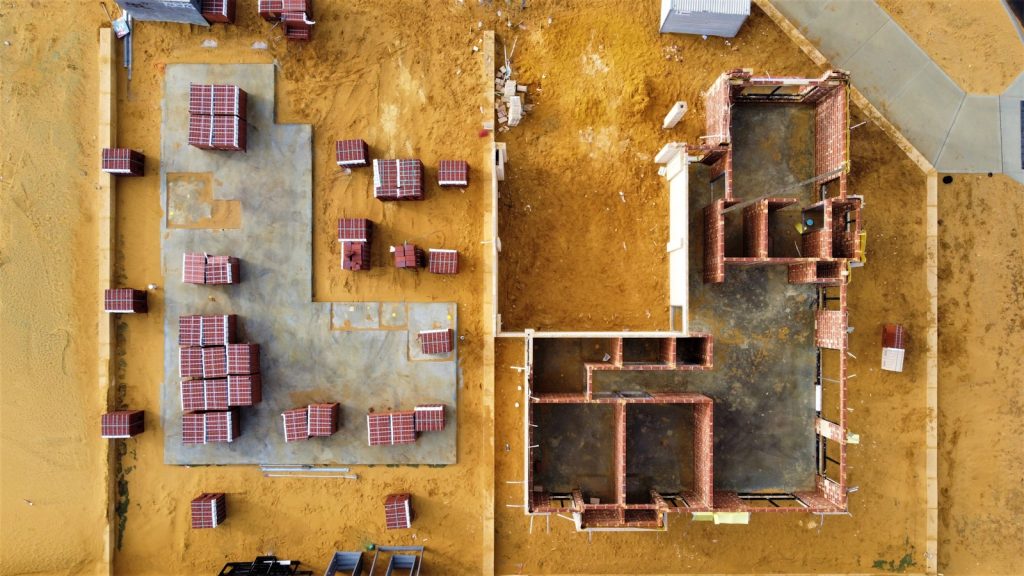 Aerial view of a building construction site, representing the cost of building and buying property in Nigeria