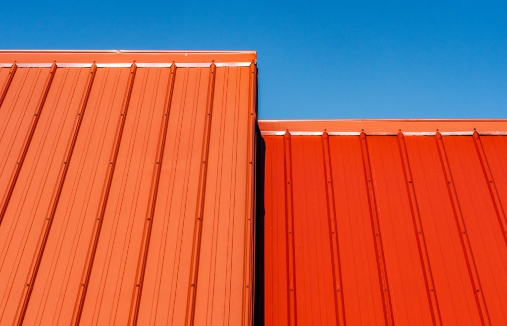 Long-span metal roofing sheets fixed on a pitched roof, illustrating roofing costs for a house in Nigeria in 2026