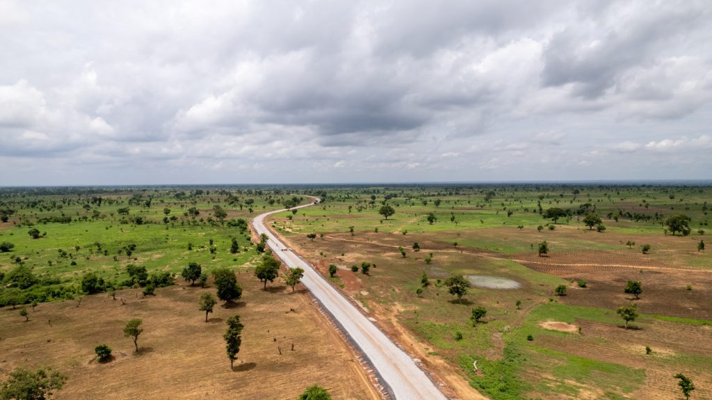 Aerial view of a new highway corridor cutting through open land, illustrating right-of-way and setback risks for Nigerian property owners in 2026