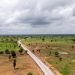 Aerial view of a new highway corridor cutting through open land, illustrating right-of-way and setback risks for Nigerian property owners in 2026