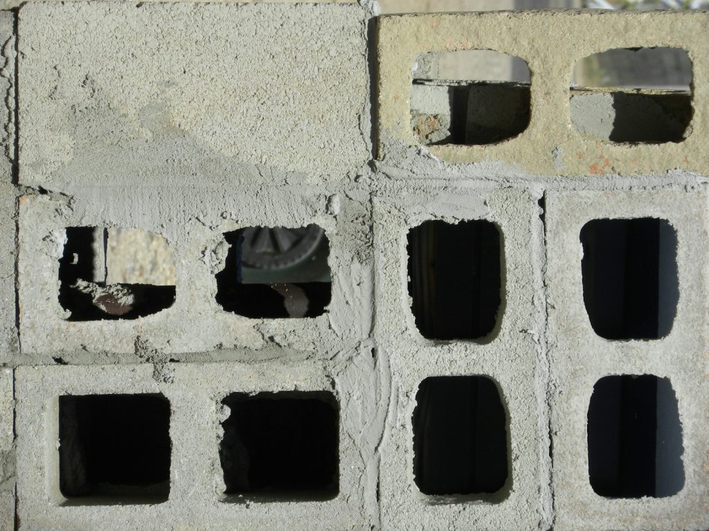 Stacked cement blocks, used to estimate how many blocks build a 3-bedroom bungalow in Nigeria