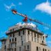 Crane beside a building under construction, representing Lagos building approvals going fully online