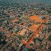 Aerial view of a dense West African residential housing estate, illustrating Nigeria's FMBN mortgage ceiling increase in 2026