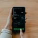 Smartphone showing a money-transfer app used to send funds safely for land in Nigeria