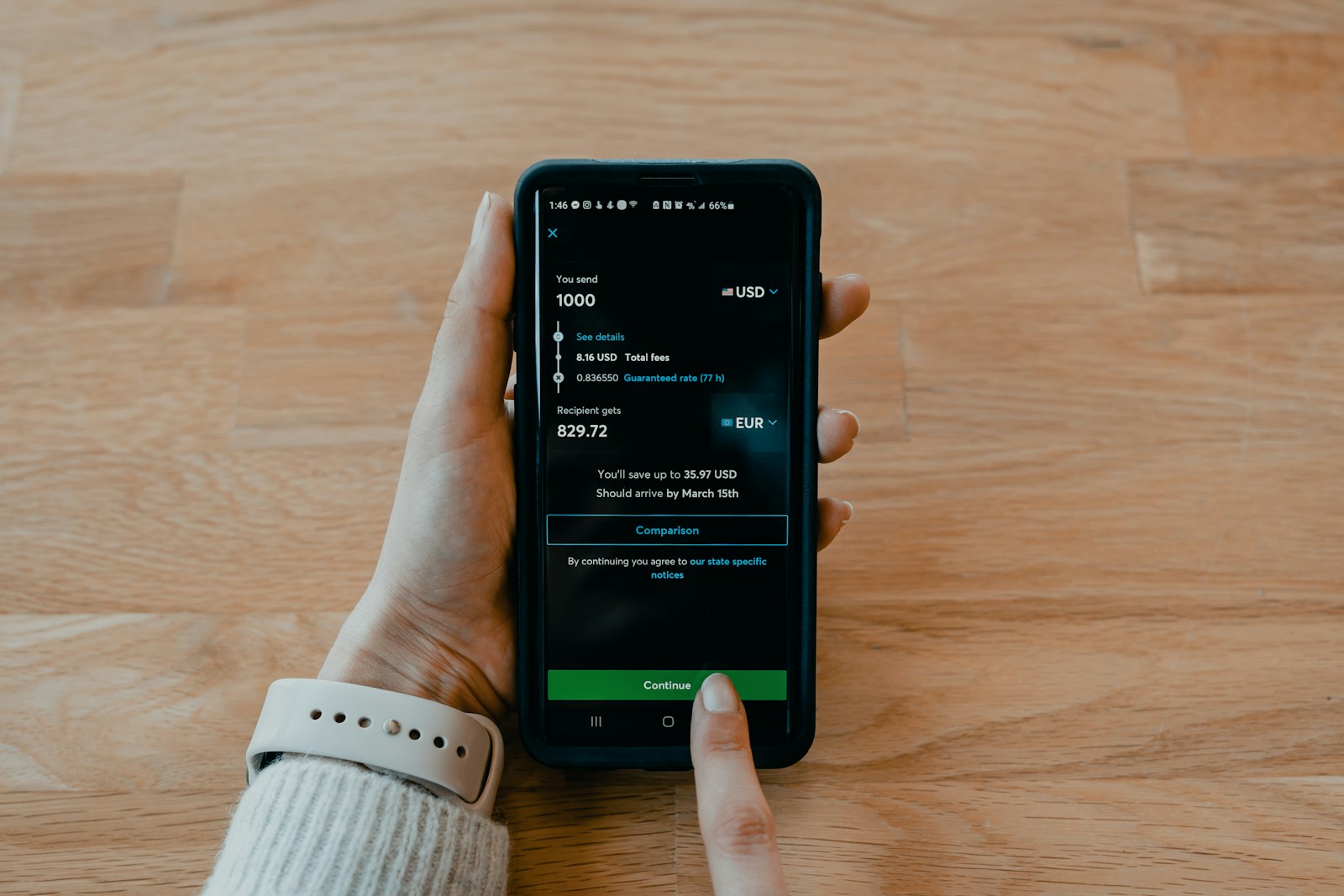 Smartphone showing a money-transfer app used to send funds safely for land in Nigeria
