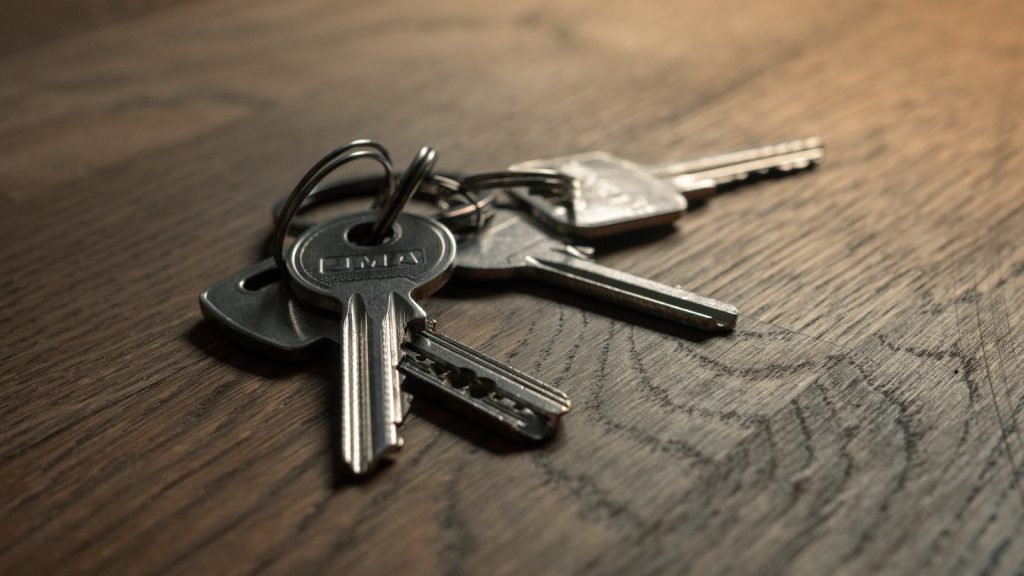 House keys resting on a signed property document, illustrating Certificate of Occupancy costs in Nigeria