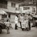 A busy Lagos street lined with small lock-up shops, illustrating the cost of building a shop in Nigeria in 2026