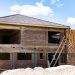 Two-storey duplex under construction in Nigeria, block walls and tiled roof, 2026