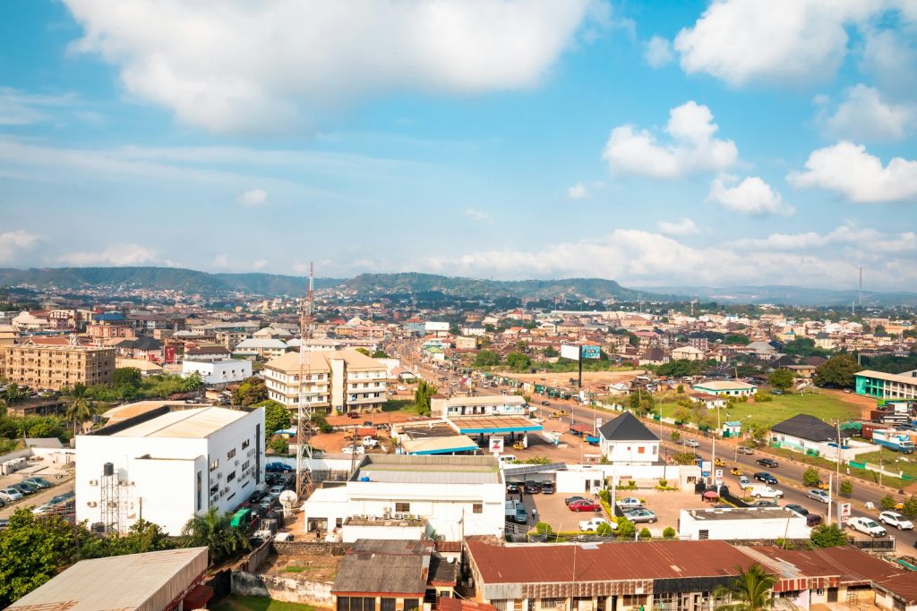 Aerial view of Enugu, the Coal City, Nigeria, showing residential rooftops among green hills, 2026