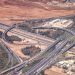 Aerial view of a multi-lane highway interchange, representing Nigerian infrastructure projects pushing up land values in 2026