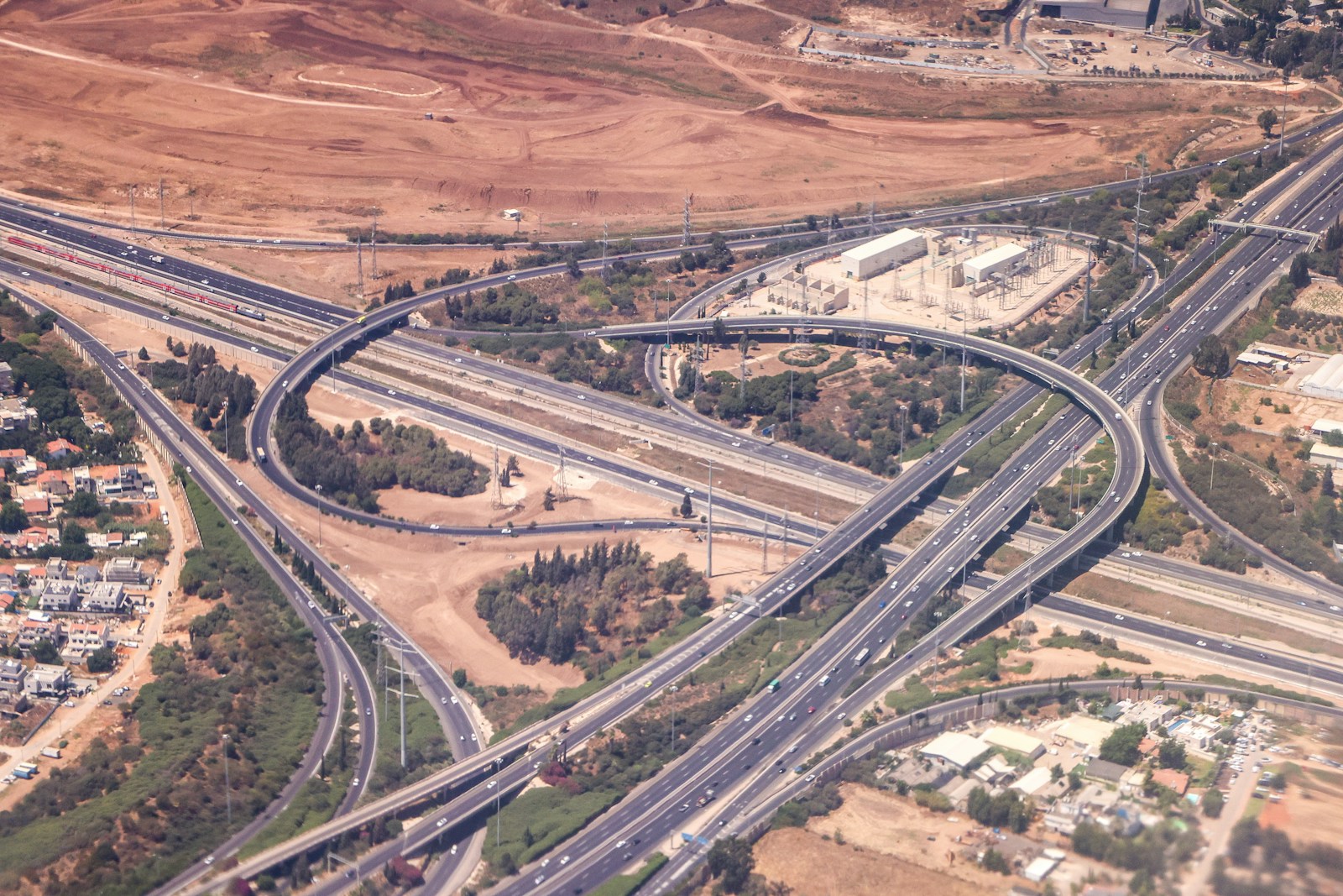 Aerial view of a multi-lane highway interchange, representing Nigerian infrastructure projects pushing up land values in 2026