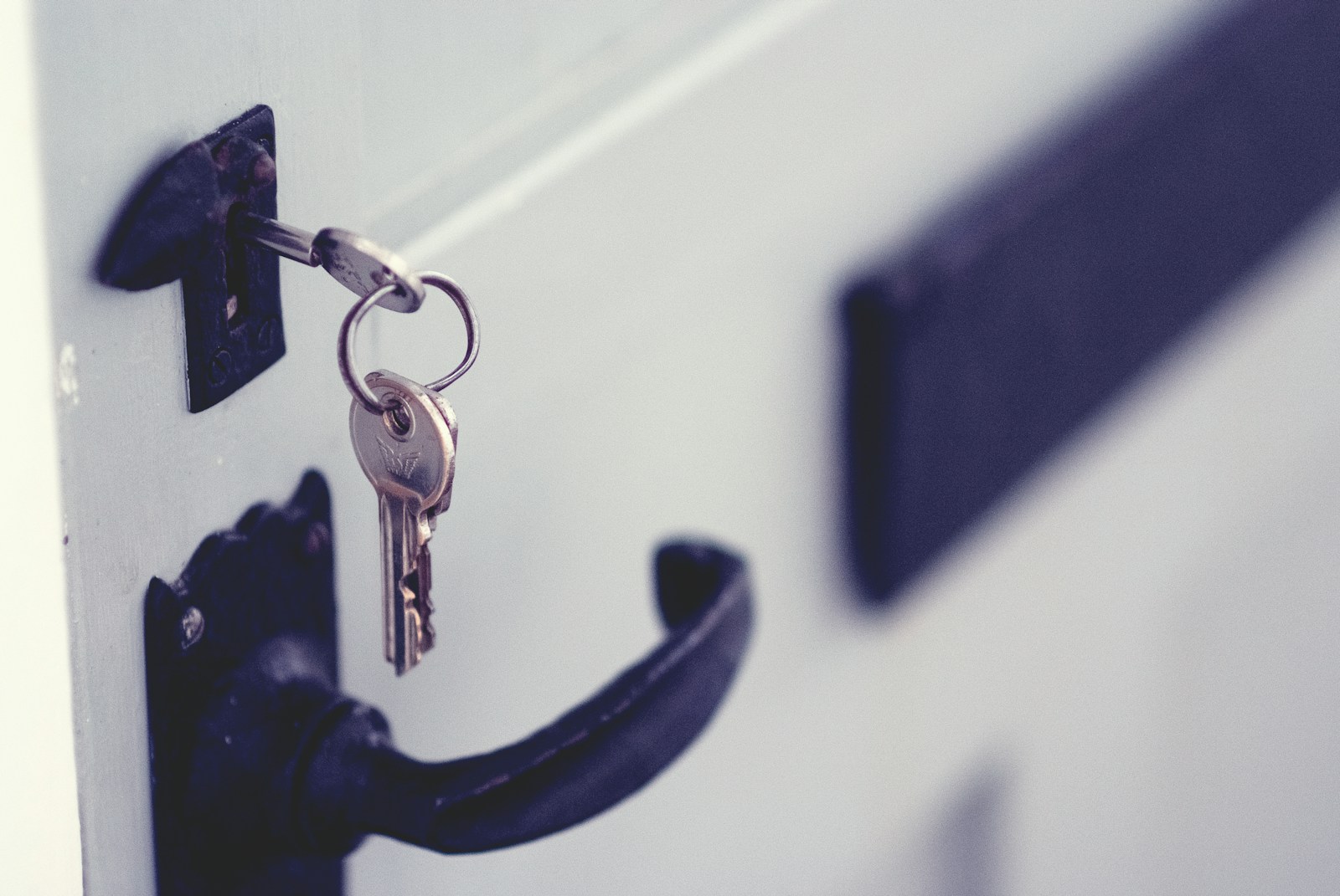 A key in a white apartment door, illustrating Lagos rent and tenancy rule changes for tenants and landlords in 2026