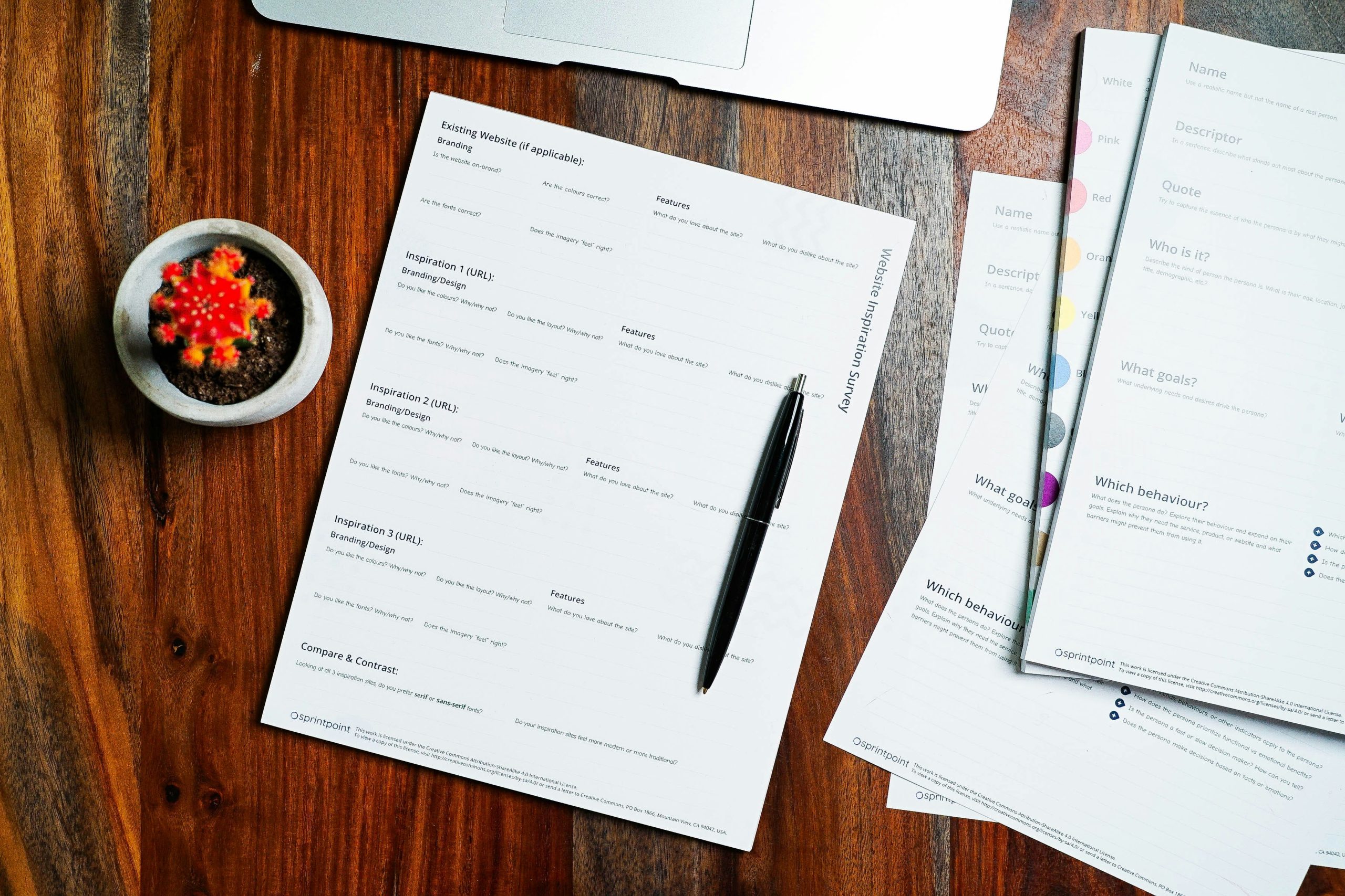 Property documents and a pen on a wooden desk, representing the land title papers a Nigerian buyer must verify before paying