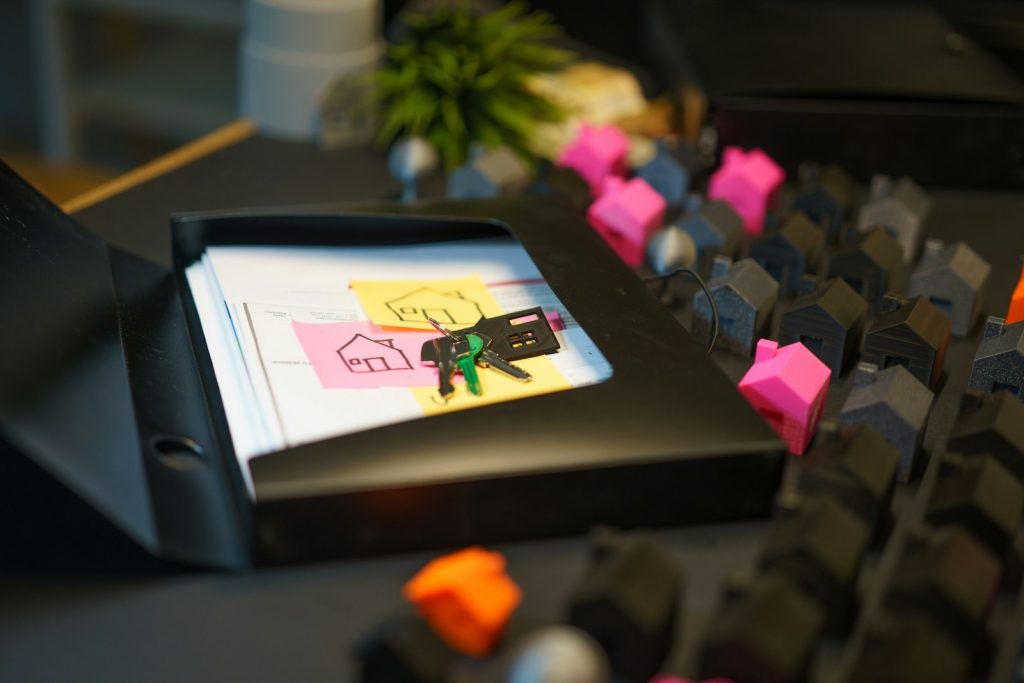 Property purchase documents and house keys on a table, illustrating LASRERA agent verification for Lagos buyers in 2026