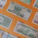 A spread of banknotes representing squeezed Nigerian household budgets as buyers delay home purchases in 2026