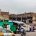Unfinished buildings along a busy street, illustrating Nigeria's 2026 off-plan housing escrow and developer-licensing reforms