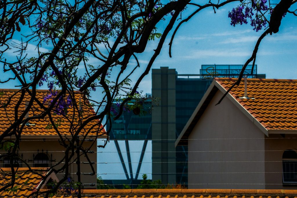 Modern residential apartment rooftops in an African city, illustrating Nigerian REIT property investment in 2026