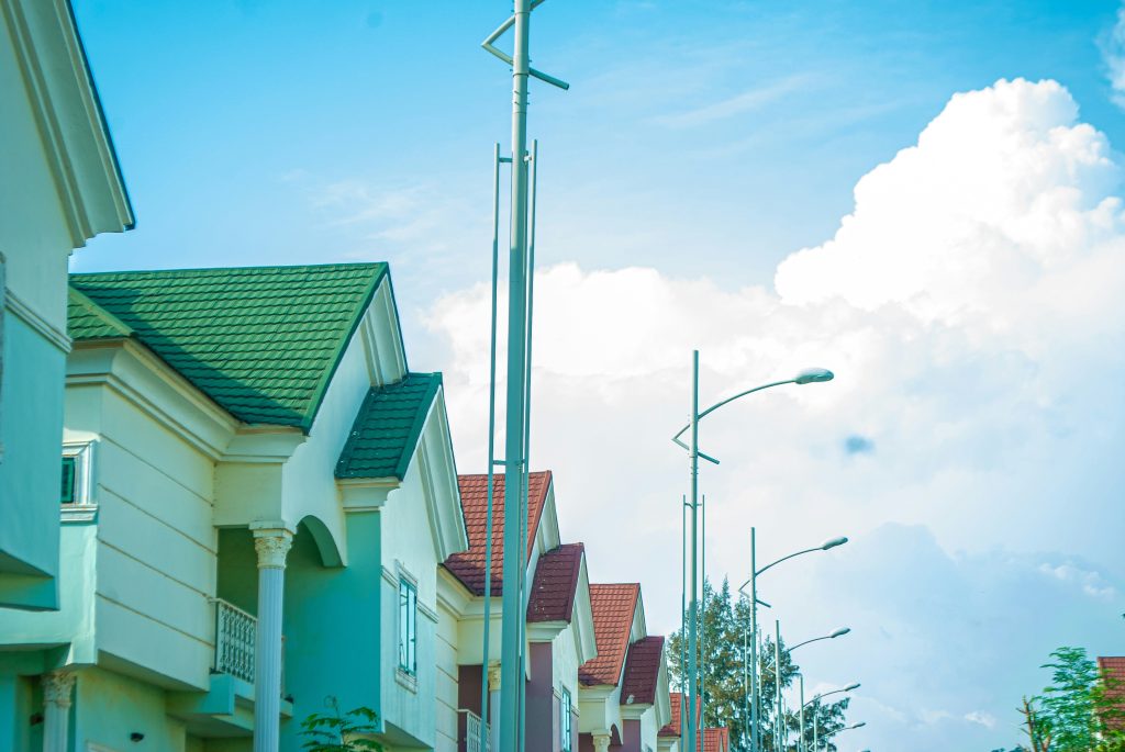 Rows of houses along a residential street in Nigeria, representing Renewed Hope affordable housing units selling in Lagos and Abuja in 2026