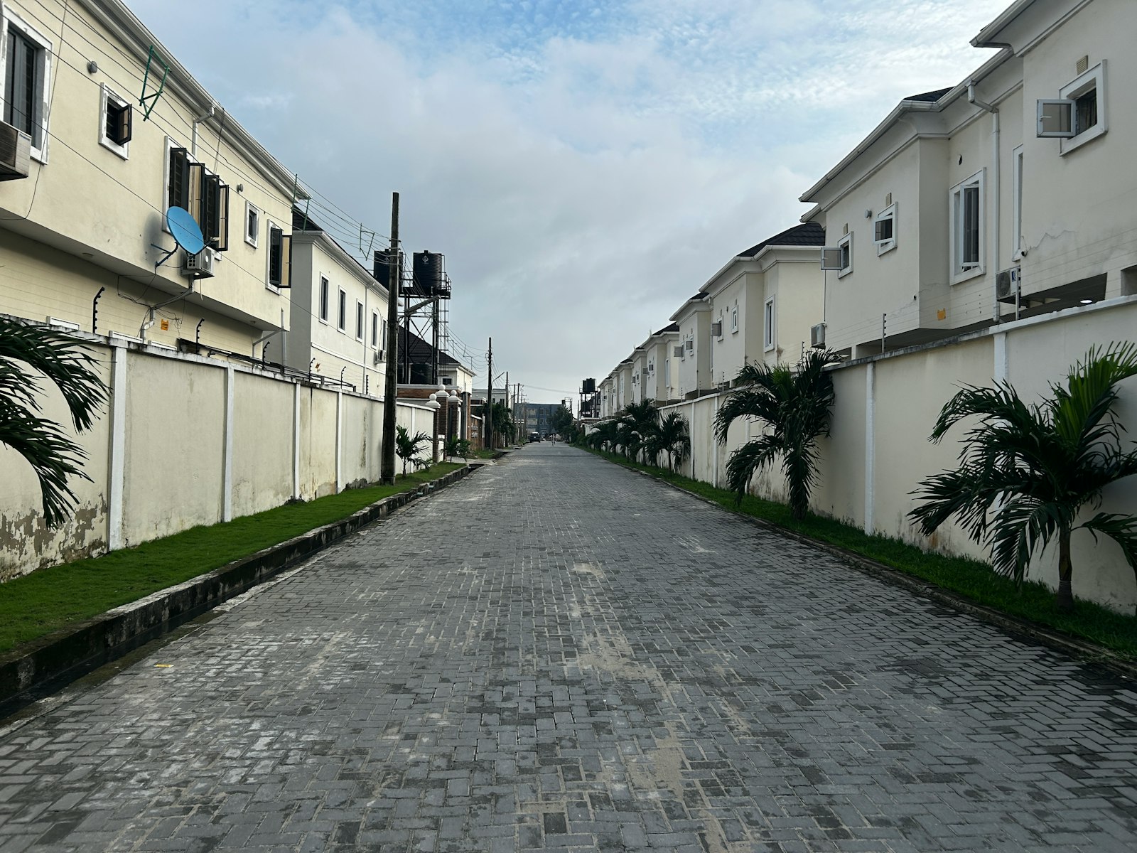 A residential street in Lagos, showing roadside drainage and plot levels relative to the road