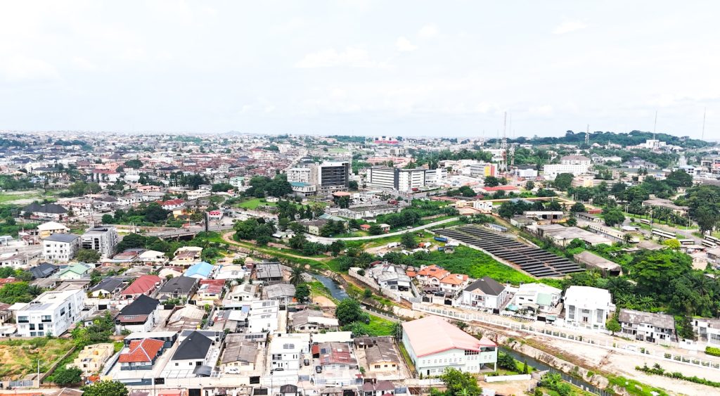Aerial view of a developing Nigerian city skyline representing top real estate investment hotspots in 2026