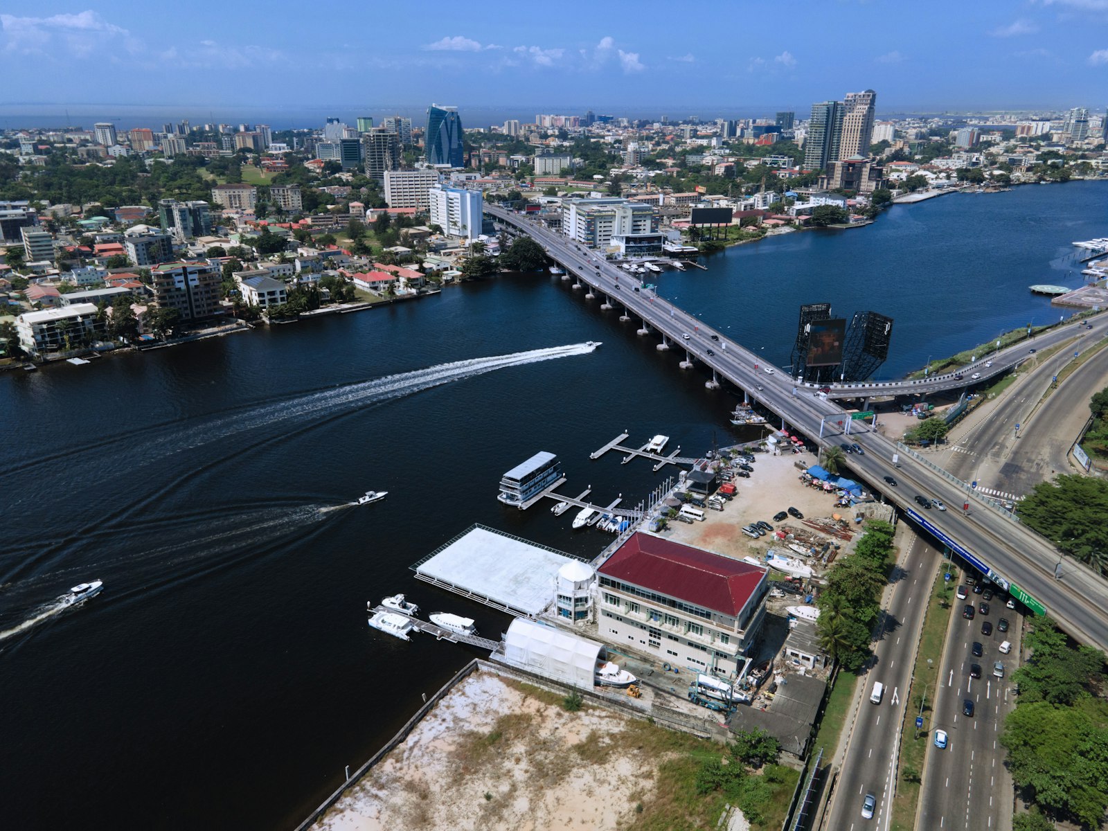 Aerial view of Victoria Island, Lagos, with boats on the lagoon and the skyline behind